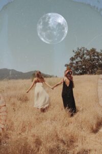 girls walking under the moon